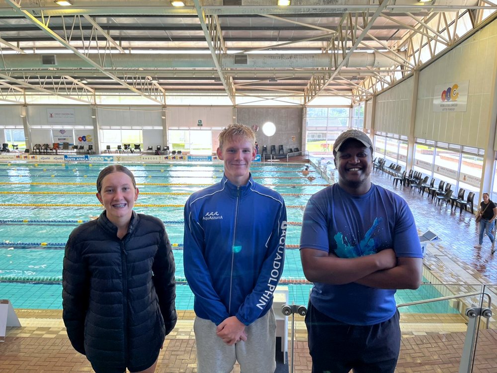 Coach and athletes poolside